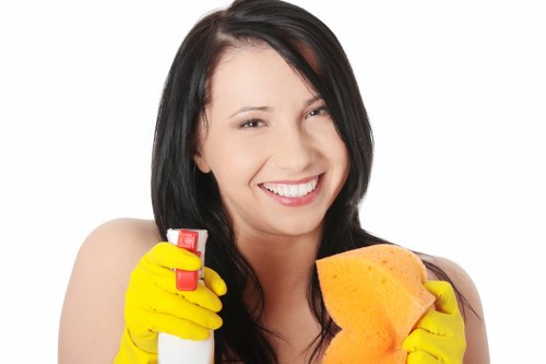 Office cleaning team sanitising shared workplace surfaces